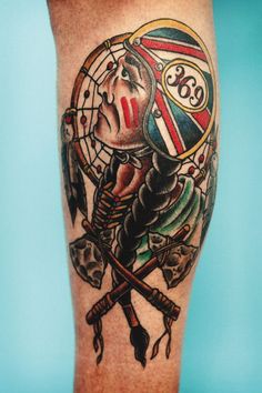 a man's leg with an old school style tattoo design on the thigh and arm