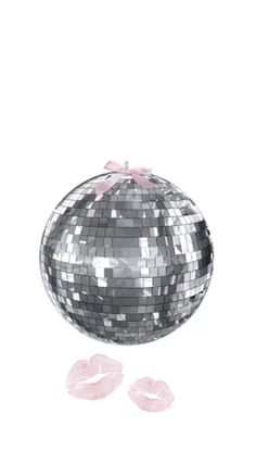 a silver disco ball with pink bows on it