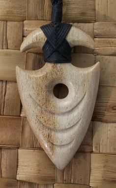 a wooden mask hanging on a wall