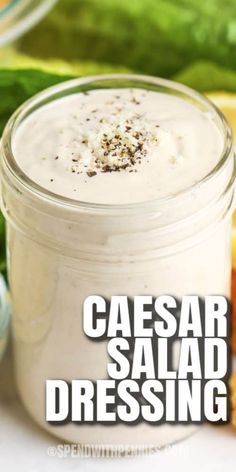 a close up of a jar of dressing with the words caesar salad dressing in it