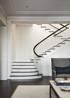 a living room filled with furniture and a spiral staircase