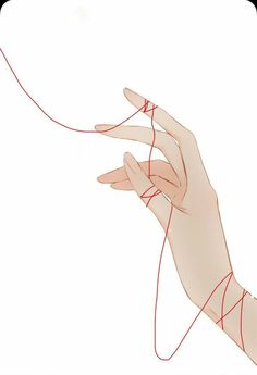 a woman's hand with red thread on it