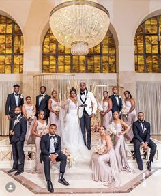 a large group of people in formal wear posing for a photo