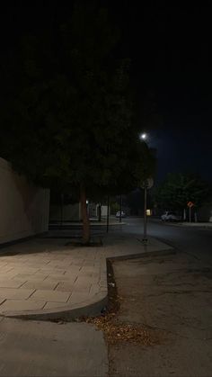 an empty street at night with no one on it or people walking down the sidewalk