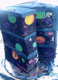 there is a cake that has been decorated with different colors and shapes on the side