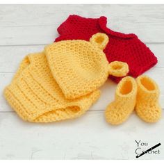 two crocheted baby hats and booties on a white wooden surface