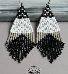 These black geometric earrings are made of high-quality Czech beads and strong synthetic thread. They are elegant, fashionable, and highly versatile, suitable for everyday wear. Features: Sterling silver components Color: Black, gray, white. This item is currently in stock. You must be completely satisfied. If you find merchandise unsatisfactory for any reason, return it within 10 days and your money will be refunded without questions. More beaded earrings http://etsy.me/2ycItdb Gerdan necklaces White Bohemian Geometric Earrings, White Geometric Bohemian Earrings, Bohemian White Geometric Earrings, White Beaded Earrings, Boho Beaded Earrings, Beadwork Earrings, Beaded Earrings Native, Gray Earrings, Native American Earrings