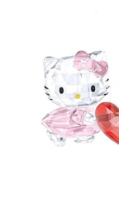 a hello kitty figurine sitting next to a heart