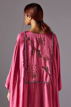 Pink kaftan kurta with a curved hemline which features metallic handwork, jacobean hand work in the shapes of nature in the front and back. Paired with dhoti in bamberg satin which has an asymmetrical hemline with handworked metallic button and loop closure.
Components: 2
Pattern: Embroidered
Type Of Work: landscape jacobean
Neckline: Notched
Sleeve Type: Flared
Fabric: Bamberg Satin
Color: Pink
Other Details: 
Asymmetric
Attached lining
Occasion: Cocktail - Aza Fashions Pink Bohemian Kurta With Cutdana, Bohemian Cutdana Kaftan For Festivals, Bohemian Kaftan With Dupatta For Spring, Festive Bohemian Kimono With Resham Embroidery, Bohemian Spring Kaftan With Dupatta, Spring Bohemian Kaftan With Dupatta, Bohemian Style Festival Kurta With Cutdana, Bohemian Festival Kurta With Cutdana, Bohemian Style Cutdana Kurta For Festivals