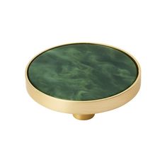 a round brass knob with green marble on it