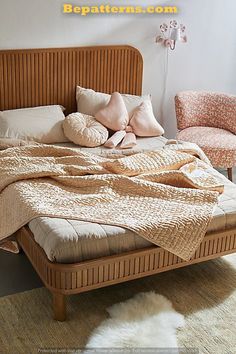 a bed with pillows and blankets on top of it