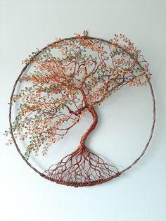 a wire tree sculpture with orange and green leaves