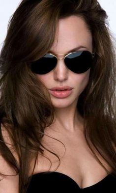 a woman with sunglasses on her face and long hair