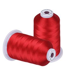 two spools of red thread sitting next to each other