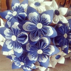 several blue and white paper flowers on a table