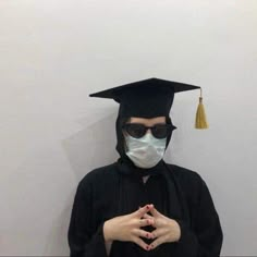 a person wearing a face mask and graduation cap