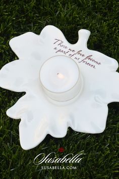 a white candle holder sitting on top of green grass with the words, there is no place