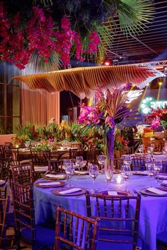 the tables are set with purple linens and place settings