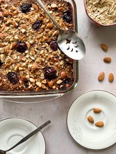 a pan filled with oatmeal and raisins on top of a table