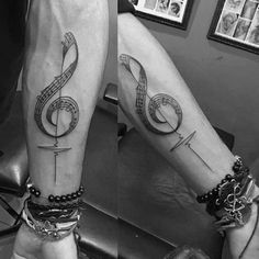 black and white photo of two people with musical notes on their legs, one has a treble