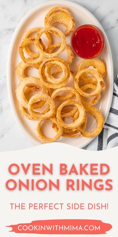 oven baked onion rings on a plate with ketchup next to it and text overlay that reads oven baked onion rings the perfect side dish