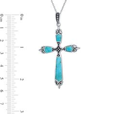 Find a fresh new look to express your faith with this elegant blue turquoise cabochon beaded fleur-de-lis cross pendant. Crafted in sterling silver This cross-shaped design features an oxidized beaded center flanked by vibrant blue turquoise cabochons along the sides - the largest an 18.0 x 5.0mm stone. Sculpted fleur-de-lis details shine at the ends while a coordinating oxidized beaded tapered bail completes the look. This pendant suspends along an 18.0-inch rolo chain that secures with a spring-ring clasp. Turquoise Sterling Silver Cross Pendant, Turquoise Sterling Silver Cross Pendant Jewelry, Elegant Turquoise Cross Jewelry, Rolo Chain, Vibrant Blue, Blue Turquoise, Turquoise Beads, Turquoise Blue, Spring Rings