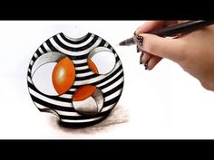 someone is drawing an orange and black object