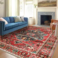 a living room filled with furniture and a red rug on top of a hard wood floor