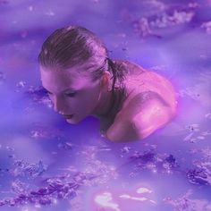 a woman is floating in the blue water