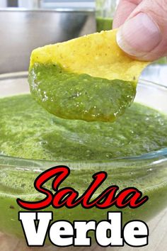 a hand dipping guacamole into a bowl with salsa in it and the words salsa verde above it