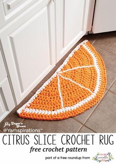 an orange crocheted rug on the floor in a kitchen