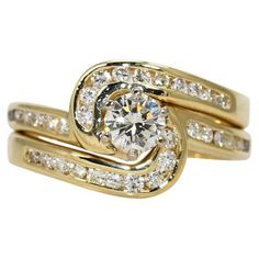 two gold wedding rings with diamonds on each band and an engagement ring in the middle