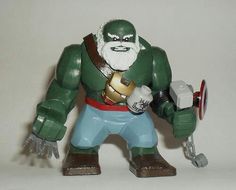 a toy figurine is holding a hammer