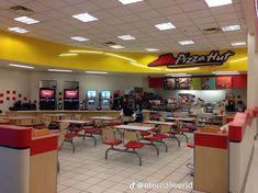 the inside of a fast food restaurant with tables and chairs