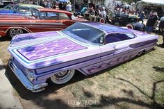 several classic cars parked on the grass at a car show