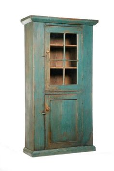 an old wooden cabinet with glass doors on the front and bottom shelves, against a white background