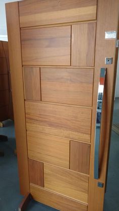 an open wooden door with metal handles