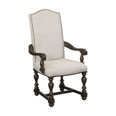 an upholstered arm chair with wooden legs and nailing on the backrest