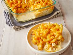 macaroni and cheese casserole on a plate next to a glass dish