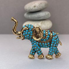 ● Looking for a vintage-style brooch as a perfect gift for her? Introducing our Elephant brooch for good luck, designed with white pearl stones on bronze, is an excellent choice for any occasion. Whether you're looking for a Birthday gift, Mother's Day gift, Bridemaids gift, or a Grandma gift, this brooch is sure to please. ● Our product is a Diplomatic Heritage Collection item that Story Design Store designer Tansel Baybara created in 2013 for the Magnificent Century TV series. The brooch is meticulously crafted by hand, and the stones are handmade by women, making it an exquisite piece of jewelry. ● The elephant represents fertility, family, power and unity. ● Your brooch will arrive in a special package with a velvet box, ensuring that it's ready to gift.      Height : 1.77 inches  (4.5 Antique Gold Brass Brooch For Gift, Handmade Turquoise Brooches As Gift, Handmade Turquoise Brooches For Gift, Turquoise Brooch Jewelry Gift, Bohemian Gold Brooches For Gifts, The Magnificent Century, Bridemaids Gift, Elephant Brooch, Story Design