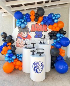 an image of balloon decorations and balloons on the table at a dragon ball birthday party