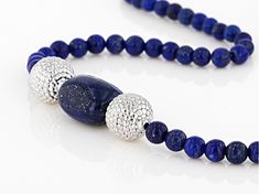 4mm-4.5mm round and approximately 15x12mm rectangular lapis lazuli  sterling silver bead necklace. Measures approximately .42"W. Lobster claw closure. Rhodium plated. Size and shape may vary. Elegant Lapis Lazuli Necklace With Polished Beads, Elegant Silver Beaded Lapis Lazuli Necklace, Silver Beaded Lapis Lazuli Necklace, Silver Lapis Lazuli Jewelry With Polished Beads, Silver Lapis Lazuli Necklace With Polished Beads, Silver Lapis Lazuli Gemstone Beads Necklace, Silver Lapis Lazuli Round Bead Jewelry, Blue Lapis Lazuli, Silver Bead Necklace