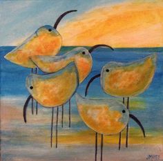 three yellow birds are standing in the sand