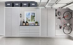 a bike is mounted to the wall in a garage with storage shelves and bins