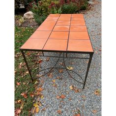 an orange table sitting on top of a gravel road