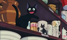 a black cat standing on top of a shelf in a room filled with dishes and vases