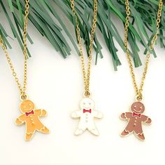 Celebrate the Christmas season with these cute and dainty Gingerbread Man Charm Necklaces! Available in brown, crisp white, and dark brown, these charms hang elegantly from an 18k gold-plated chain, adding a touch of festive to your ensemble. Whether you're looking for the perfect stocking stuffer or a special gift, these necklaces are the epitome of holiday cuteness. 🎄 Details: - Necklace Length: 18 inches, thoughtfully equipped with a 2-inch lobster claw extender for a customized fit  - Necklace Material: 18k gold-plated stainless steel - Charm Material: gold-plated alloy, measuring 0.55 inches in width and 0.78 inches in height. Caring for Your Cherished Necklace: - After each wear, gently wipe it with a soft cloth to maintain its radiant charm. - Ensure your necklace stays dry by remo Cute Gold Jewelry For Christmas, White Necklace For Holiday Gift, Brown Necklaces With Lobster Clasp As Gift, Brown Necklace With Lobster Clasp For Gift, Brown Necklace With Lobster Clasp As Gift, Gingerbread Man Christmas, Charm Necklaces, Perfect Stocking Stuffers, Jewelry Christmas