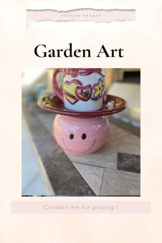 the cover of garden art, featuring a pink vase with hearts on it and a smiling face