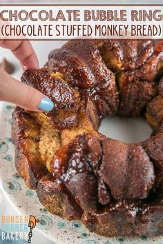 chocolate bubble ring cake on a blue and white plate with the words chocolate stuffed monkey bread