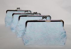 four light blue lace purses are lined up on a white surface, one is empty